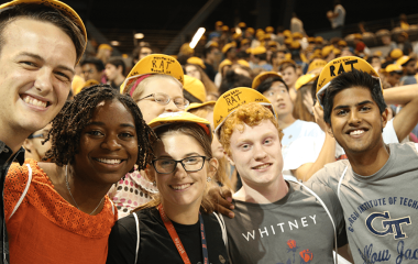 students in caps smiling